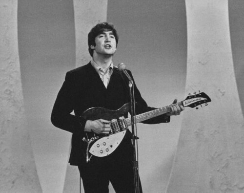 Guitarist John Lennon (1940-1980) of English pop group The Beatles performs before television cameras (playing his 1958 Rickenbacker 325 guitar) during a recording of The Ed Sullivan Show at CBS's Studio 50 in New York City on 9th February 1964. (Photo by Paul Popper/Popperfoto via Getty Images)